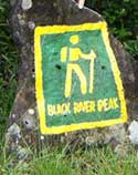 Hiking path information stone Black River peak hiking sign