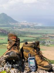 Boots and GPS overlooking Black River Illustration of modern hiking